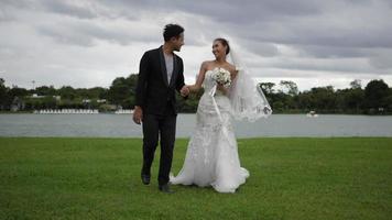 slow motion van bruiloft bruid en bruidegom gelukkig plezier in het park video