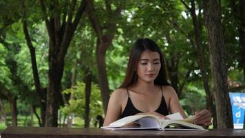 Beautiful woman reading knowledge from a book video