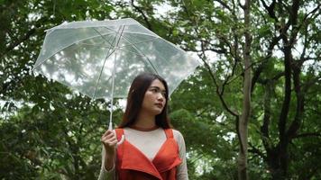 Alone woman hand holding umbrella in the rain video