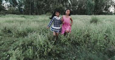 Two little girls running around the park video