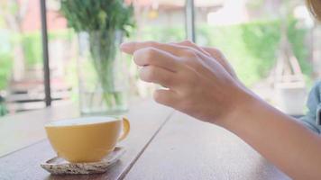 Female blogger photographing green tea cup in cafe with her phone. video