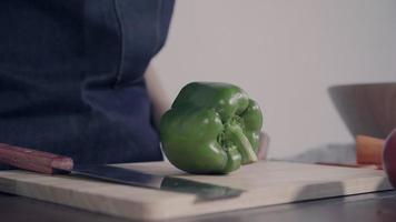 Close up of chief woman making salad healthy food and chopping bell pepper on cutting board. video