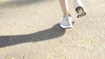Slow motion - Young asian woman running on sidewalk in morning. video