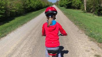 Camera follows a girl on bicycle in 4K video