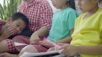 Asian mother playing with children at living room floor. video