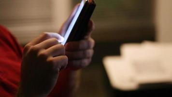 Man stands near window in hotel room and uses smartphone video