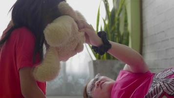 Mother is playing with her daughter in living room. video