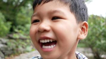 Close up of a laughing boys face after hearing a joke video