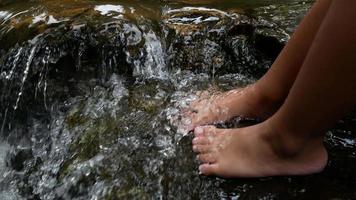 Close up feet in waterfall. video