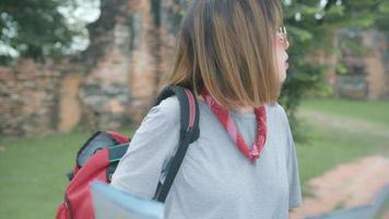 Traveler Asian woman direction and looking on location map while spending holiday trip at Ayutthaya, Thailand. video