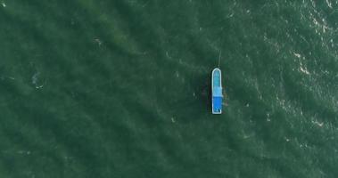 Top view of a blue boat sailing in the sea video