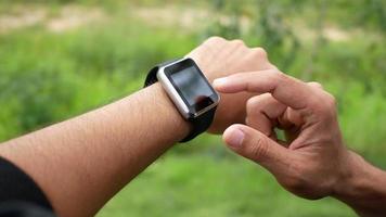 Hand touching on screen of smart watch