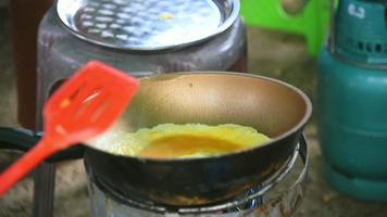 Woman frying omelette in pan