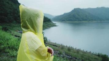 Young Asian woman enjoying the rain  video