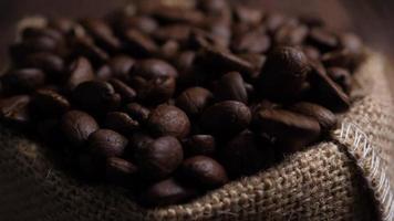 Brown roasted coffee beans falling on pile  video