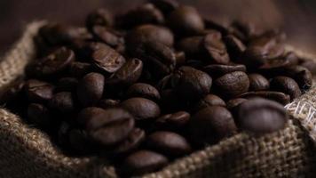 Brown roasted coffee beans falling on pile video