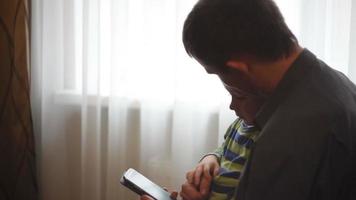 Father And Son Playing Game On Cell Phone video
