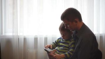 Father And Son Playing Game On Cell Phone video