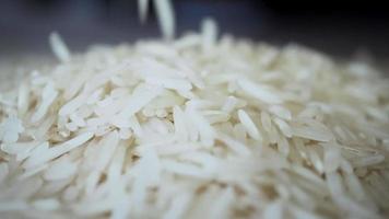 White rice falls in slow motion close up video