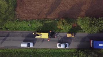 Machine asphalting road top down view in 4K video