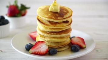 Pancakes with butter, strawberries, blueberries and honey video