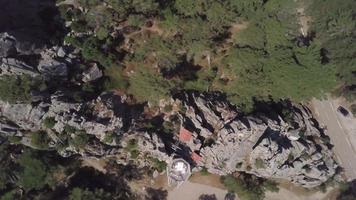 Top down view of a rock with cabins in 4K video