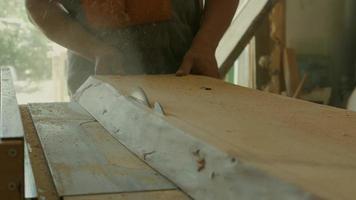 Carpenter using Table Saw to Cut Big Plank video