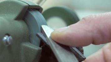 Master Sharpens the Blade of the Plane on the Grinding Machine video