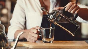 Professional barista pouring coffee on a cup  video