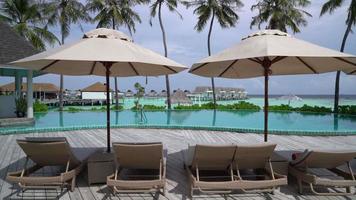 Beach chair close to swimming pool video