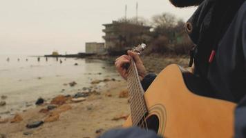 Playing guitar near the sea