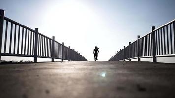 Silhouette woman running on the bridge