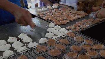 Thai vendors cooking Kanom Babin on a hot griddle video