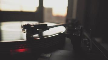 A record player spinning in early morning setting video