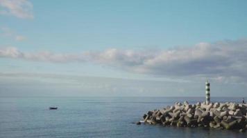 Lonely boat floating near the end of a pier video