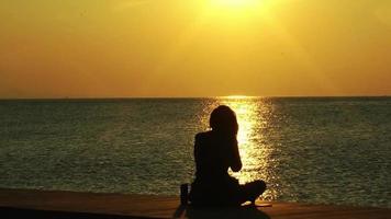 Woman Watching The Sea At A Yellow Sunset video