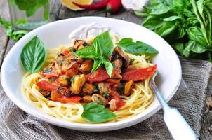 pasta with mussels, pepperoni, bacon, tomato and basil photo