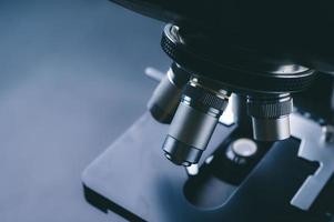 Close-up of scientific microscope with metal lens, data analysis in the laboratory photo