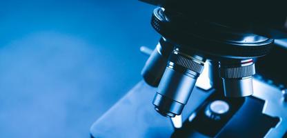 Close-up of scientific microscope with metal lens, data analysis in the laboratory photo