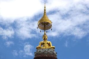 Gold Buddha statue in front of sky photo