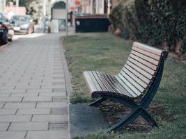 wooden bench near bush photo