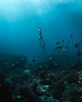 Woman in black shorts diving in the sea photo