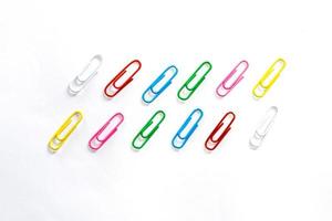 Colorful paperclips on white background photo