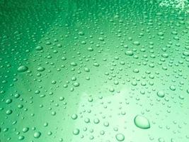 Close-up de gotas de lluvia sobre una superficie translúcida