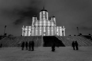 People standing at a church at night photo