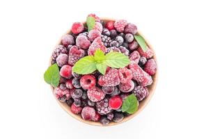 Frozen mixed berries on white background photo