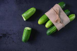 Fresh cucumber on black background photo