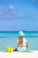 Girl sitting on a beach photo