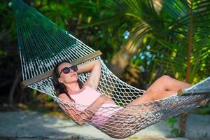 Woman relaxing in a hammock photo