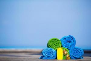 Towels and sunscreen on a dock photo